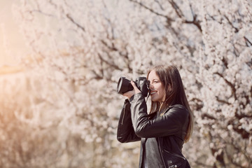 Beautiful female photographer working outdoors