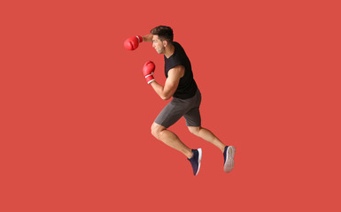 Fototapeta na wymiar Sporty male boxer on color background