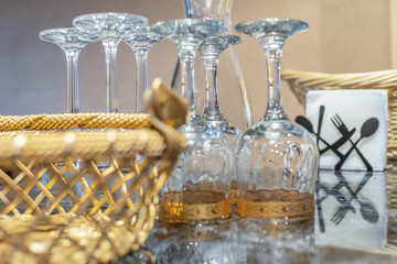 Inverted glasses on the table close-up, next to there are napkins, a wicker basket