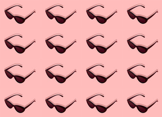 seamless pattern stylish black sunglasses on pink background Flat lay