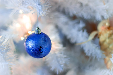 Blue bubble hanging on silver christmas tree, good as background.