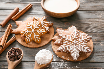 Composition with tasty Christmas cookies and milk on wooden table