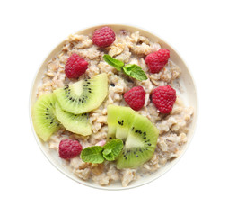 Bowl with tasty sweet oatmeal on white background