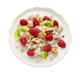 Bowl with tasty sweet oatmeal on white background