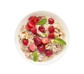Bowl with tasty sweet oatmeal on white background