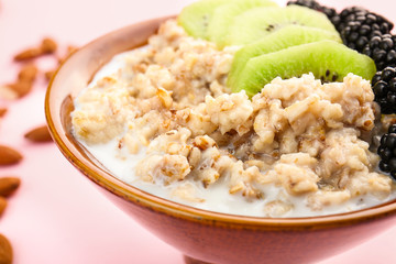 Bowl with tasty sweet oatmeal, closeup