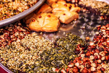 Assortment of oriental sweets on a large plate on the market. Close-up.