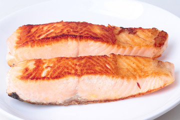 2 Grilled salmon steaks on white plate