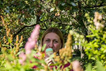 White smiling woman 42 years old blonde with hair Bob in the Park among the trees on a Sunny summer...