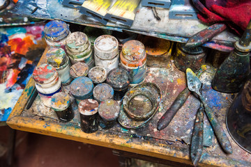 Artistic paintbrushes, paints and palette knifes