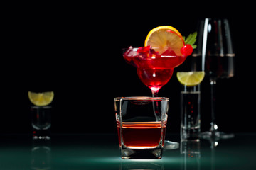 Various alcoholic drinks on a black background.
