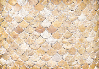 Decorative pieces of marble texture on concrete wall  in many layer fish  scale shaped seamless patterns  , horizontal light brown background © Amphawan