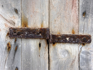 Old wooden door surface background with rusty metal 