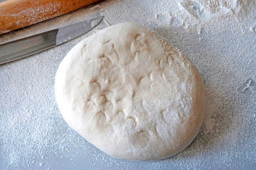 Processing dough on the table with hands and rolling pin. Dumplings, dumplings, ravioli, filled with cherries, strawberries, berries. The concept of cooking sweet dishes , desserts.