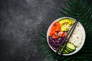 Poke bowl on black top view.