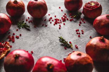 Pomegranate fruit. Ripe and juicy pomegranate on rustic grey background