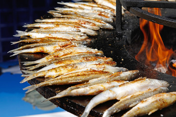 Fried smelts on large barbecue fire bowl