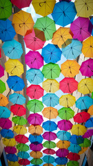 Fototapeta na wymiar Multicolored rainbow colorful umbrellas hung over Bordeaux street France