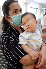 Asia Infant is strabismus and Have eyes closed for physical in treatment.