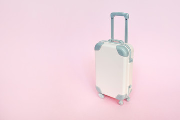 Stylish suitcase on pink background, top view with place for text. Concept for travel with place for your text