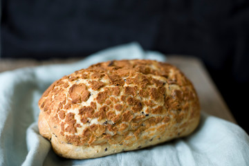 sourdough fresh bread loaf on the table dark background