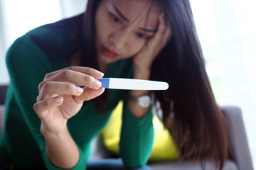 Asian beautiful women are stressed and worried about pregnancy results. Pregnancy beyond...