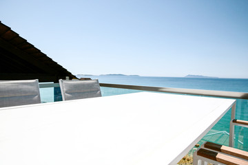 White table with chairs on the beautiful ocean view.