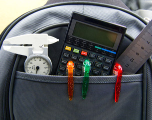 Backpack with different school supplies. Back to school