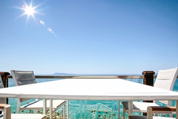White table with chairs on the beautiful ocean view.