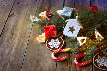 Christmas background with electric garland lighting, sweets, decorations and gifts on a wooden...