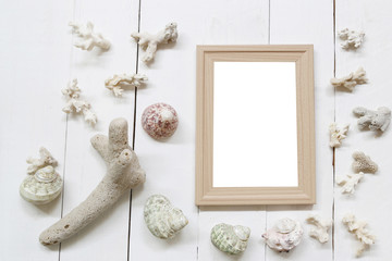 Wooden photo frame on a white wood floor and have Shells and coral reefs.