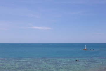 Fototapeta na wymiar Lighthouse in sea and blue sky on daytime,Tropical sea in Thailand.