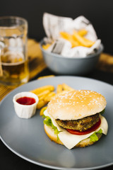 High angle close-up burger with fries on plate