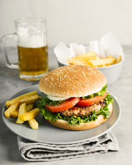 High angle close-up burger with fries on plate