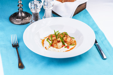  Mediterranean fish on a mashed potato pillow with tomato sauce