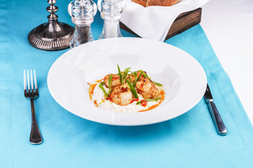  Mediterranean fish on a mashed potato pillow with tomato sauce