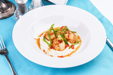  Mediterranean fish on a mashed potato pillow with tomato sauce