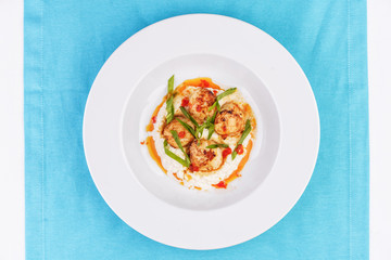  Mediterranean fish on a mashed potato pillow with tomato sauce