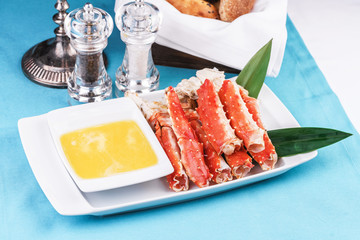  European recipe, Mediterranean dish. Boiled crab legs served with oil sauce and bamboo leaves