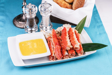  European recipe, Mediterranean dish. Boiled crab legs served with oil sauce and bamboo leaves