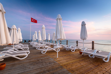 Beautiful scenery with wooden pier on Turkish Riviera at sunset, Side