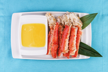  European recipe, Mediterranean dish. Boiled crab legs served with oil sauce and bamboo leaves