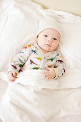 Fototapeta na wymiar baby on the parents bed