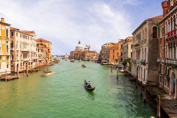 picturesque view at a Venezia Grand chanel vith gondola and nice old builginds around