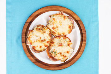 European recipe, Mediterranean dish. Baked mollusks in the oven under the cheese cap and greens according to the national recipe
