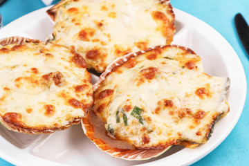 European recipe, Mediterranean dish. Baked mollusks in the oven under the cheese cap and greens according to the national recipe