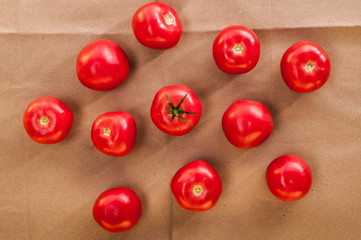 Naklejka na ściany i meble fresh pink tomatoes on craft paper background. top view