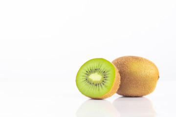 Kiwi fruit whole and halves with reflect shadow isolated on white background