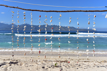 Seashells hanging on the ropes on a tropical beach in Gili Meno Island, Lombok, Indnonesia