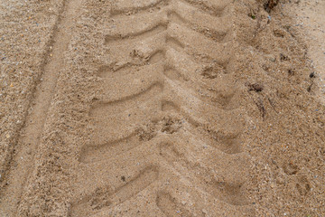 trace of tractor tire in the sand